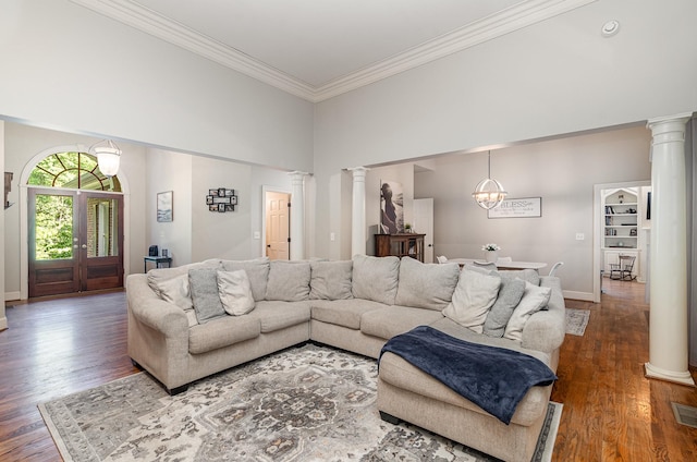 256 Scenic Dr, Dickson, TN 37055 - living room featuring decorative columns, crown molding, wood finished floors, baseboards, and a chandelier