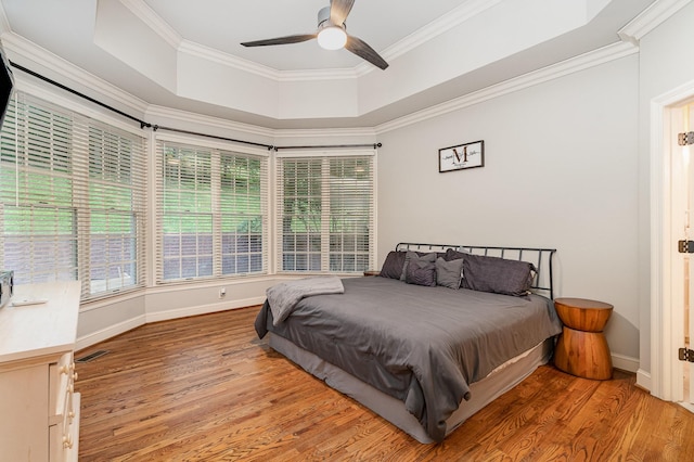 256 Scenic Dr, Dickson, TN 37055 - bedroom featuring light wood-style floors, a tray ceiling, ornamental molding, baseboards, and ceiling fan