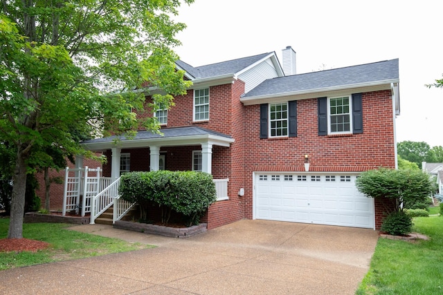 1106 Olde Cameron Ln, Franklin, TN 37067 - view of front facade with concrete driveway, covered porch, brick siding, and a chimney