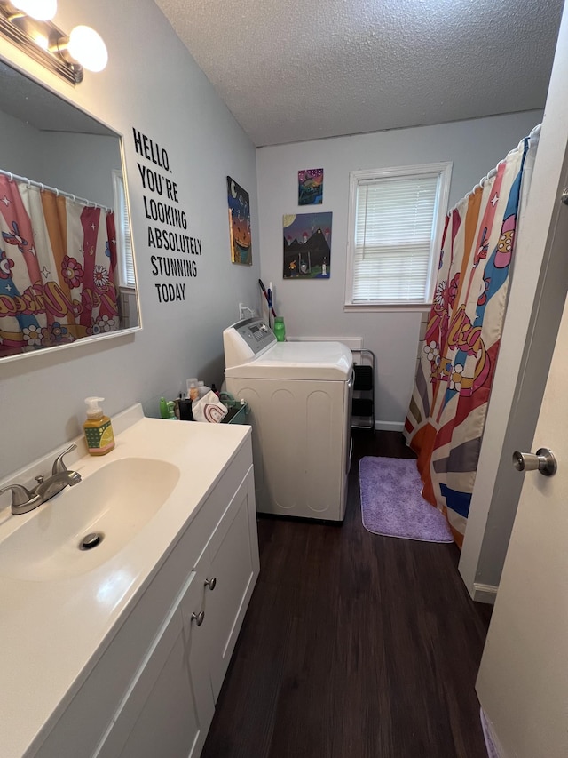 962 3rd St, Tracy City, TN 37387 - full bath with wood finished floors, a textured ceiling, washer and clothes dryer, vanity, and curtained shower