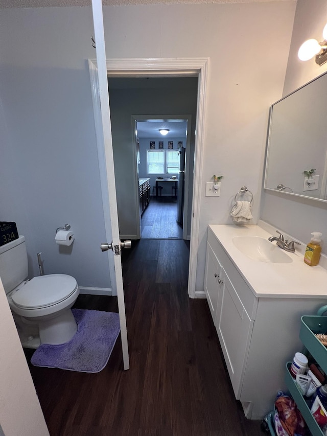 962 3rd St, Tracy City, TN 37387 - half bathroom with wood finished floors, vanity, toilet, and baseboards
