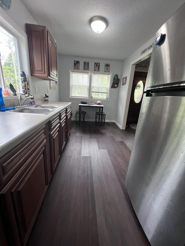 962 3rd St, Tracy City, TN 37387 - kitchen with freestanding refrigerator, light countertops, a sink, plenty of natural light, and a textured ceiling