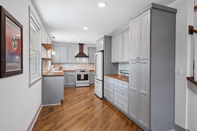 1607 Riverside Dr, Nashville, TN 37216 - kitchen with stainless steel stove, wall chimney exhaust hood, high end fridge, decorative backsplash, and butcher block countertops