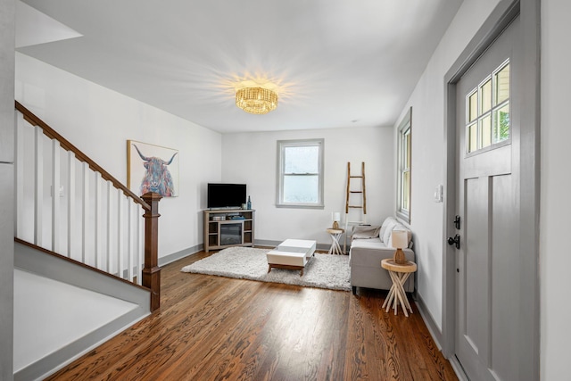 1607 Riverside Dr, Nashville, TN 37216 - living room featuring stairway, wood finished floors, baseboards, and a chandelier