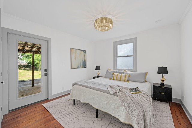 1607 Riverside Dr, Nashville, TN 37216 - bedroom with wood finished floors, ornamental molding, access to exterior, baseboards, and a chandelier
