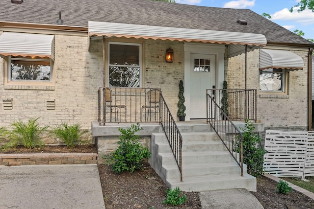 1607 Riverside Dr, Nashville, TN 37216 - doorway to property featuring brick siding and roof with shingles
