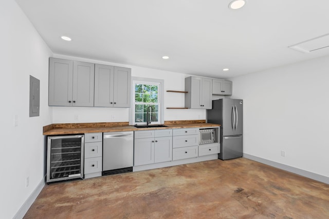 1607 Riverside Dr, Nashville, TN 37216 - kitchen with appliances with stainless steel finishes, wine cooler, a sink, gray cabinetry, and open shelves