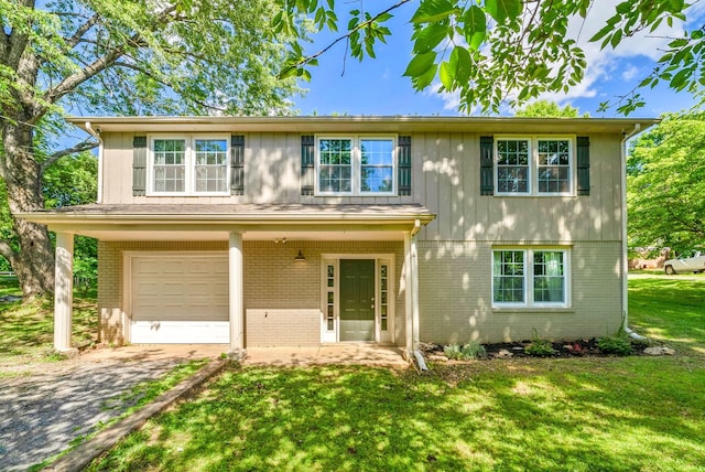 521 Rotary Hills Ct, Clarksville, TN 37043 - view of front of house with brick siding, an attached garage, a front lawn, and dirt driveway