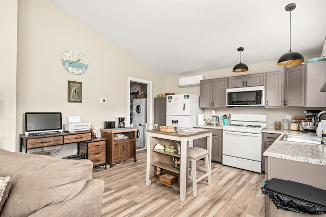 3269 Moodyville Rd, Byrdstown, TN 38549 - kitchen featuring white appliances, stacked washer and clothes dryer, gray cabinets, a sink, and a wall unit AC
