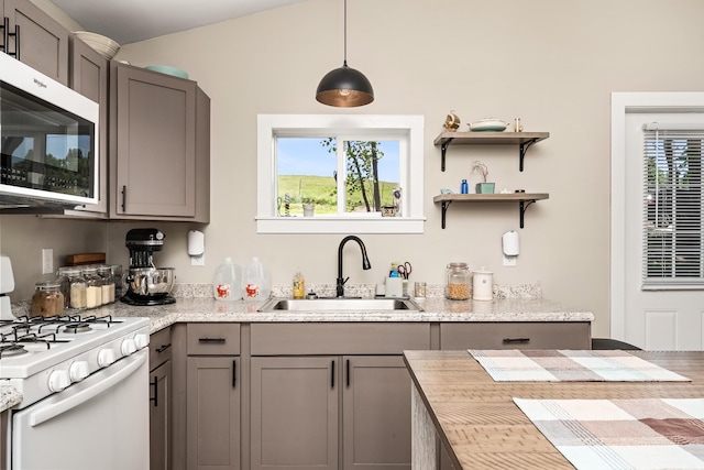 3269 Moodyville Rd, Byrdstown, TN 38549 - kitchen featuring white gas range oven, a sink, gray cabinetry, and healthy amount of natural light