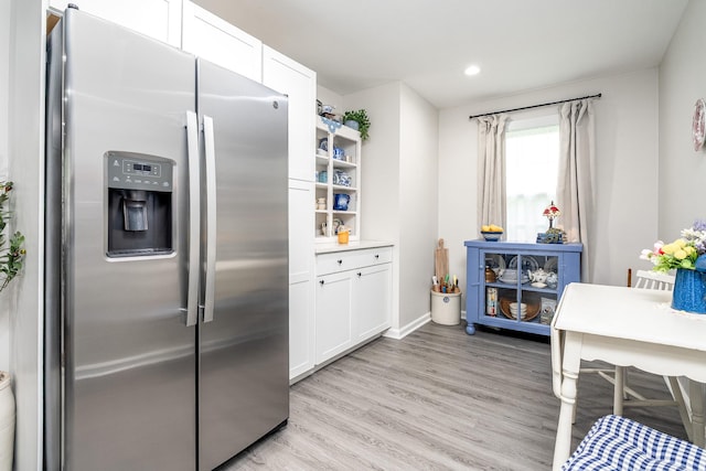 107 Beech St, Columbia, TN 38401 - kitchen with stainless steel fridge, light wood-style floors, white cabinetry, recessed lighting, and baseboards