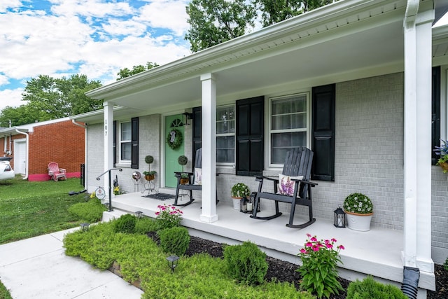107 Beech St, Columbia, TN 38401 - doorway to property featuring a porch, brick siding, and a yard