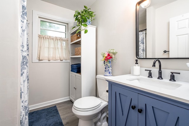 107 Beech St, Columbia, TN 38401 - full bathroom with vanity, toilet, wood finished floors, and baseboards