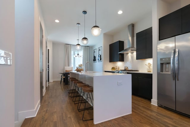2910 Felicia St Unit 19, Nashville, TN 37209 - kitchen with stainless steel fridge, wall chimney range hood, dark cabinetry, a kitchen bar, and recessed lighting