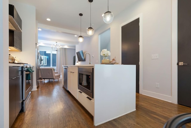2910 Felicia St Unit 19, Nashville, TN 37209 - kitchen featuring appliances with stainless steel finishes, modern cabinets, dark wood-style flooring, decorative light fixtures, and recessed lighting
