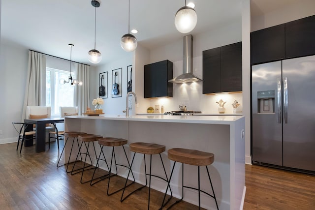 2910 Felicia St Unit 19, Nashville, TN 37209 - kitchen with stainless steel refrigerator with ice dispenser, wall chimney exhaust hood, dark cabinetry, light countertops, and dark wood-type flooring