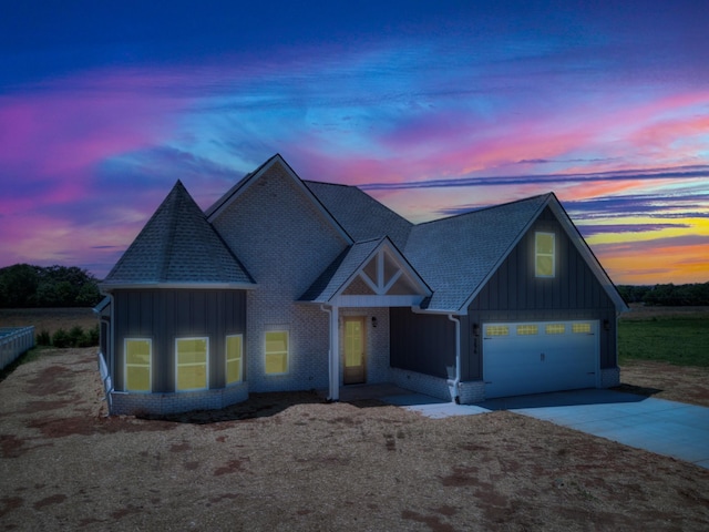 296 Lookout Dr, Winchester, TN 37398 - view of front facade with board and batten siding, concrete driveway, a shingled roof, and an attached garage