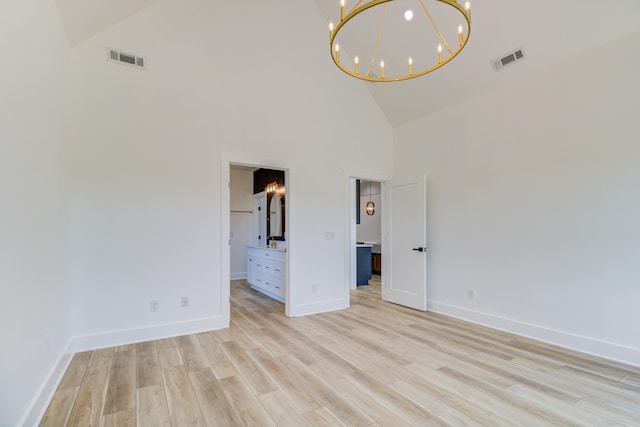296 Lookout Dr, Winchester, TN 37398 - unfurnished room with high vaulted ceiling, a chandelier, light wood finished floors, and baseboards