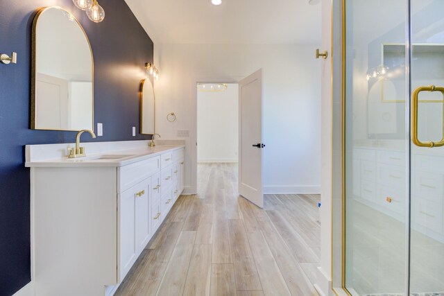 296 Lookout Dr, Winchester, TN 37398 - bathroom with double vanity, wood finished floors, a shower with shower door, baseboards, and recessed lighting