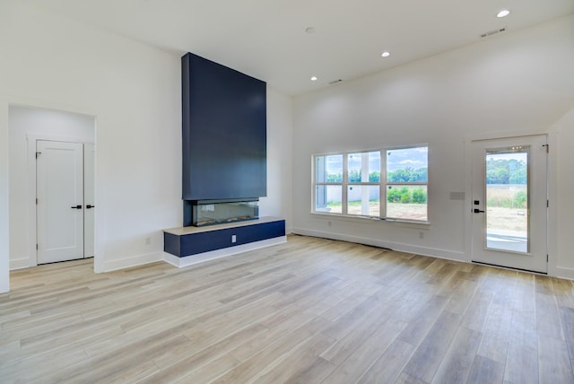 296 Lookout Dr, Winchester, TN 37398 - unfurnished living room featuring light wood finished floors, a high ceiling, baseboards, and recessed lighting