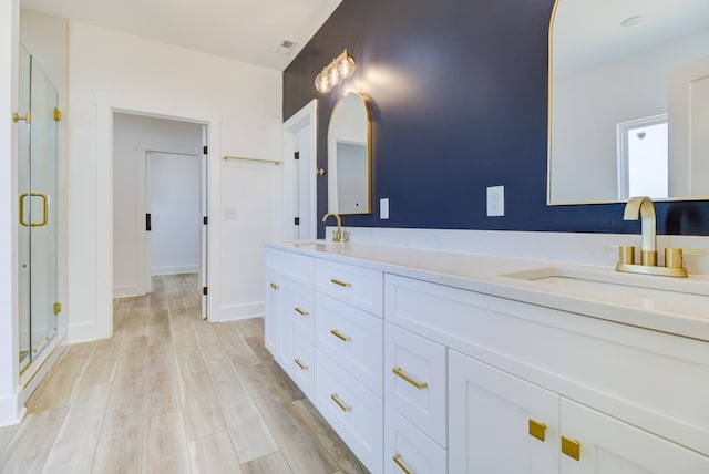 296 Lookout Dr, Winchester, TN 37398 - full bathroom featuring double vanity, a shower stall, and wood finished floors