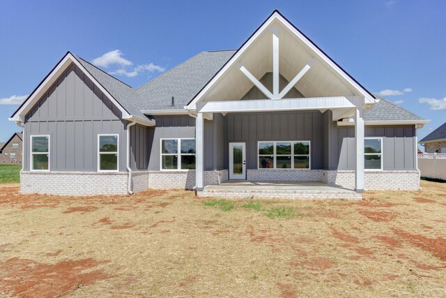 296 Lookout Dr, Winchester, TN 37398 - back of house featuring board and batten siding, a patio area, a shingled roof, and brick siding