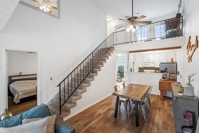 919 Rachels Pl, Hermitage, TN 37076 - dining area with a ceiling fan, stairs, a high ceiling, and wood finished floors