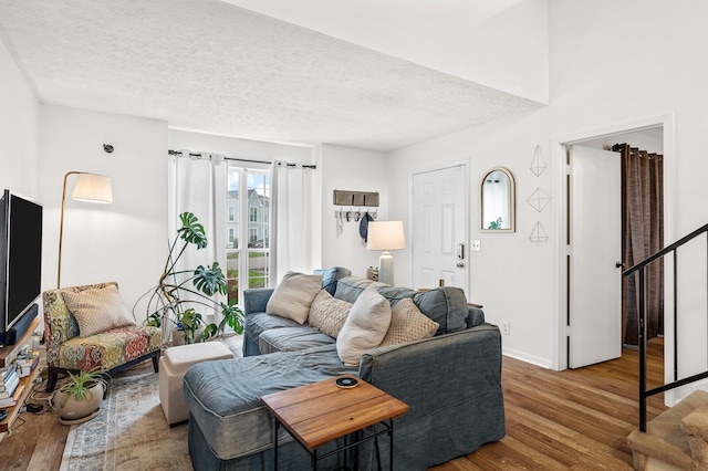919 Rachels Pl, Hermitage, TN 37076 - living area featuring wood finished floors, a textured ceiling, stairway, and baseboards