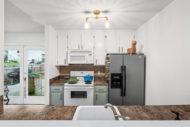919 Rachels Pl, Hermitage, TN 37076 - kitchen with white appliances, dark countertops, white cabinetry, a sink, and decorative backsplash