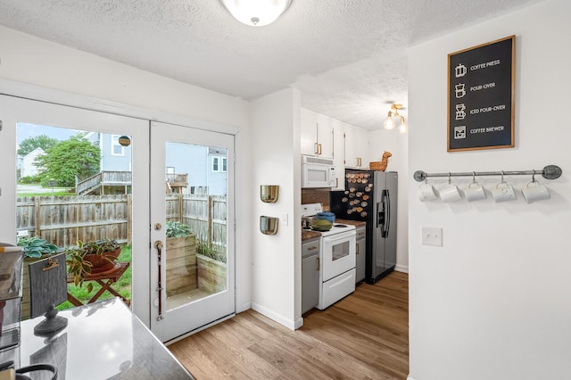 919 Rachels Pl, Hermitage, TN 37076 - kitchen with white appliances, light wood finished floors, a textured ceiling, white cabinets, and french doors
