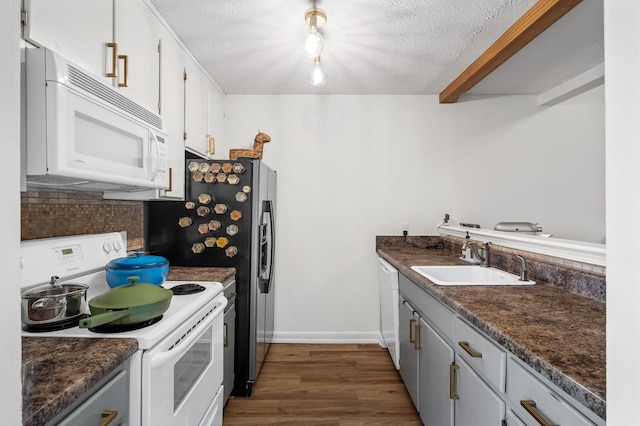 919 Rachels Pl, Hermitage, TN 37076 - kitchen featuring white appliances, a sink, dark countertops, and a textured ceiling