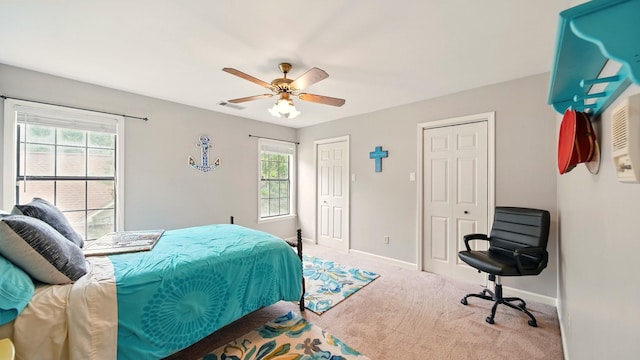 2458 Carrollwood Ln, Cordova, TN 38016 - bedroom featuring multiple closets, multiple windows, carpet flooring, and baseboards