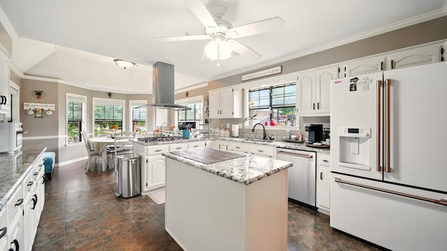 2458 Carrollwood Ln, Cordova, TN 38016 - kitchen with stainless steel appliances, island range hood, a peninsula, ornamental molding, and white cabinets