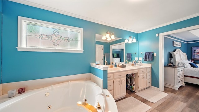 2458 Carrollwood Ln, Cordova, TN 38016 - bathroom featuring vanity, a whirlpool tub, wood finished floors, crown molding, and a chandelier