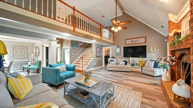 2458 Carrollwood Ln, Cordova, TN 38016 - living area featuring high vaulted ceiling, stairs, a fireplace, light wood-style floors, and a ceiling fan