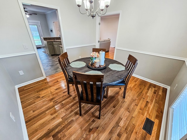 300 Woodson Dr, Tullahoma, TN 37388 - dining room with a chandelier, light wood-style floors, and baseboards