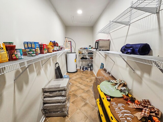 300 Woodson Dr, Tullahoma, TN 37388 - laundry room featuring water heater and light tile patterned flooring