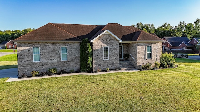 300 Woodson Dr, Tullahoma, TN 37388 - view of front facade with a front yard, brick siding, and a shingled roof