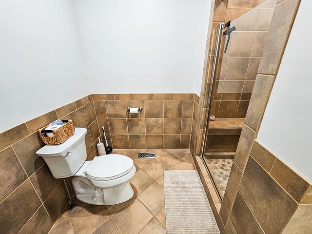 300 Woodson Dr, Tullahoma, TN 37388 - full bath with toilet, a stall shower, tile walls, and wainscoting