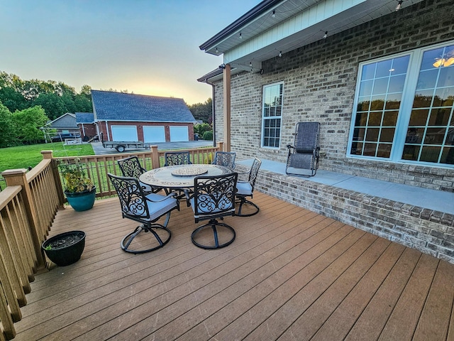 300 Woodson Dr, Tullahoma, TN 37388 - deck at dusk with outdoor dining space and an outbuilding