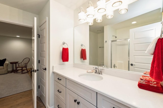 611 Lake Reserve Cv, Hermitage, TN 37076 - bathroom with a shower stall, vanity, and wood finished floors