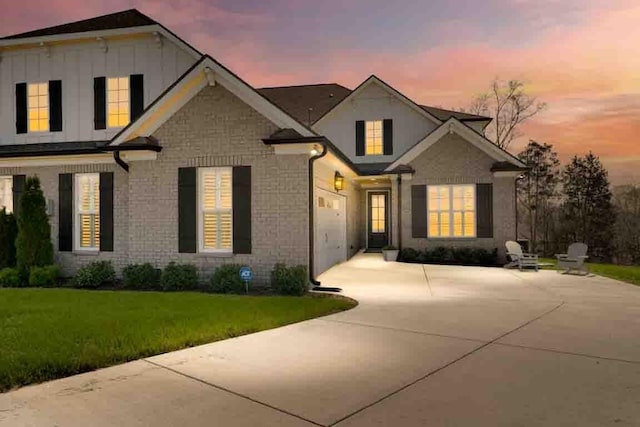 611 Lake Reserve Cv, Hermitage, TN 37076 - view of front of house with concrete driveway, a front yard, and board and batten siding