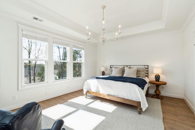 611 Lake Reserve Cv, Hermitage, TN 37076 - bedroom with a raised ceiling, light wood-type flooring, a chandelier, ornamental molding, and baseboards