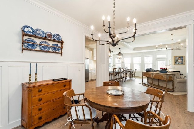611 Lake Reserve Cv, Hermitage, TN 37076 - dining space featuring a chandelier, ornamental molding, light wood-style floors, wainscoting, and a decorative wall