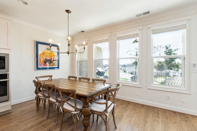 611 Lake Reserve Cv, Hermitage, TN 37076 - dining space featuring baseboards, light wood-style flooring, crown molding, and a chandelier