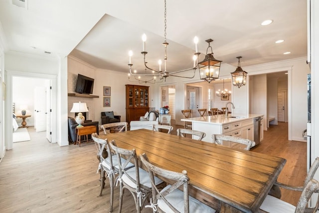 611 Lake Reserve Cv, Hermitage, TN 37076 - dining space featuring light wood-type flooring, ornamental molding, a chandelier, and recessed lighting
