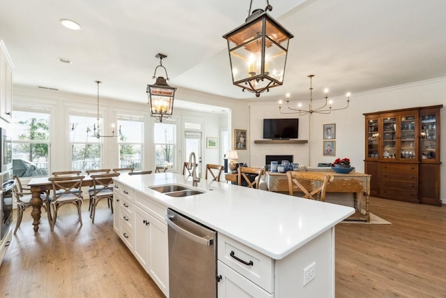 611 Lake Reserve Cv, Hermitage, TN 37076 - kitchen featuring stainless steel appliances, a sink, a chandelier, a fireplace, and recessed lighting