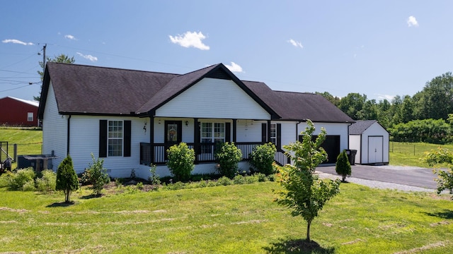 1807 Mosley Ferry Rd, Chapmansboro, TN 37035 - view of front of house with covered porch, an attached garage, asphalt driveway, a front yard, and a shingled roof