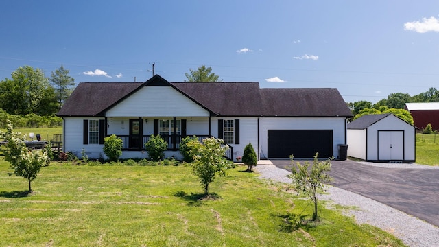 1807 Mosley Ferry Rd, Chapmansboro, TN 37035 - ranch-style home featuring a porch, an attached garage, a front yard, and asphalt driveway