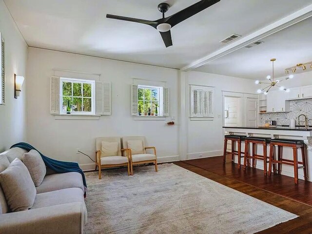 816 Charles Pl, Memphis, TN 38112 - living room featuring ceiling fan, plenty of natural light, a chandelier, and baseboards